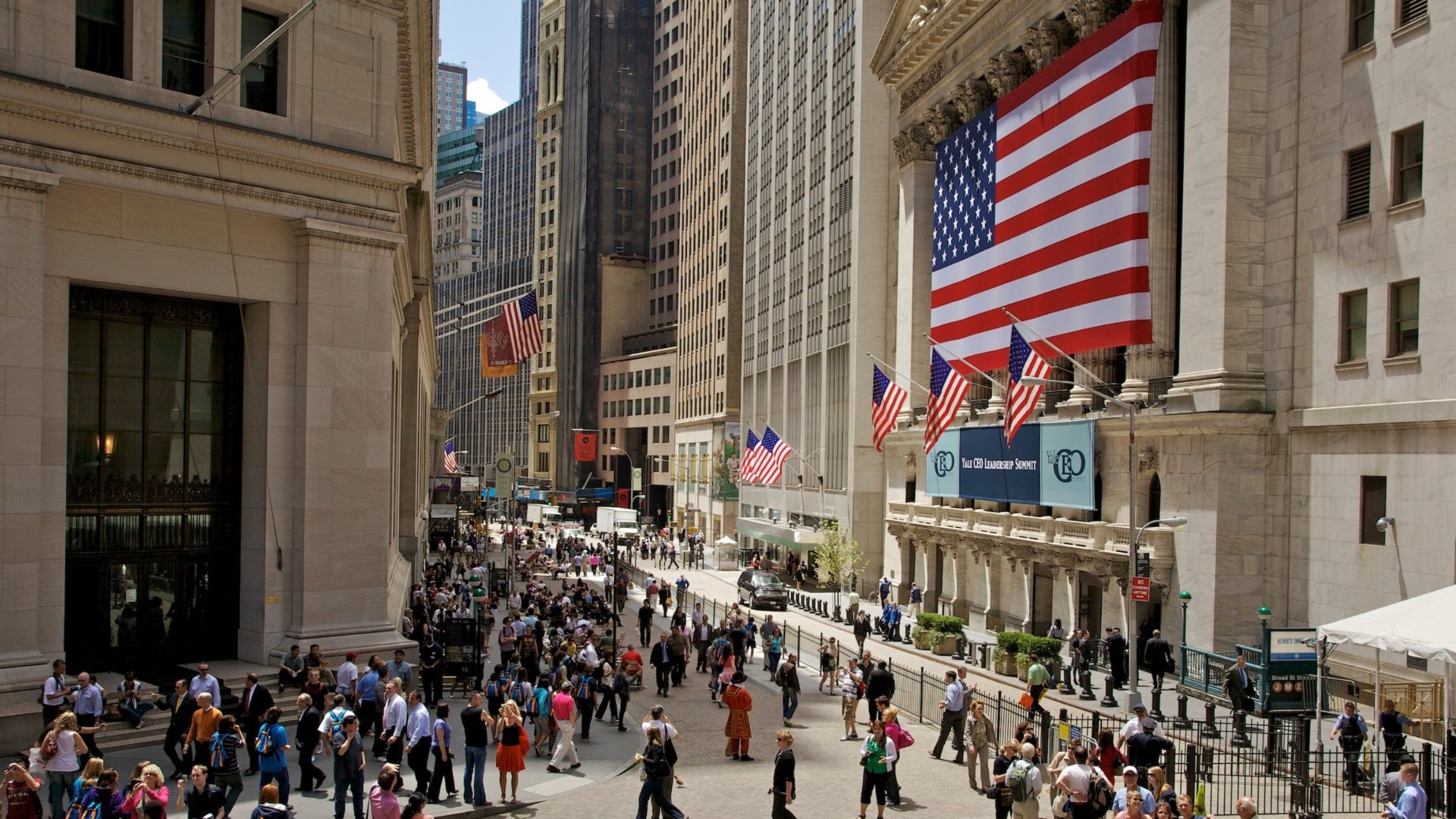 Wall Street and New York Stock Exchange with American flags in Financial District