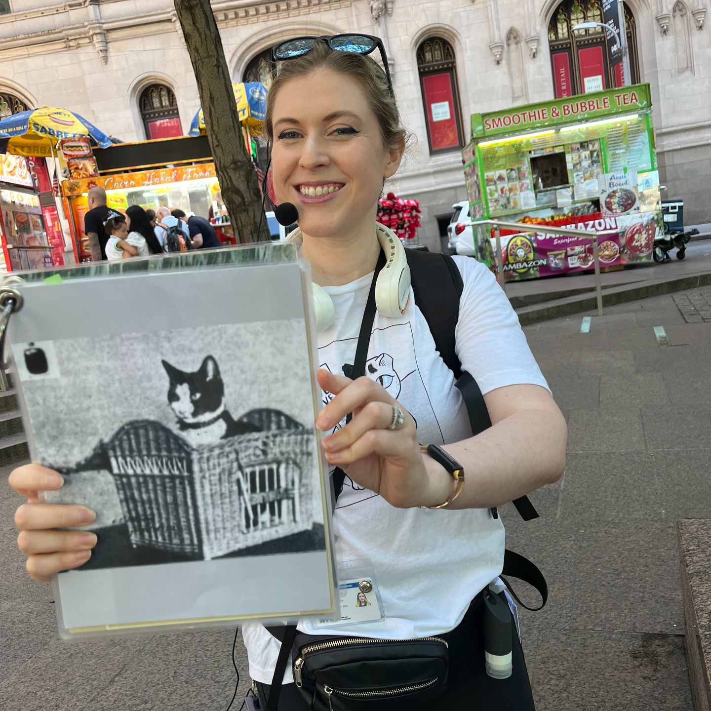 Tour guide holding historical cat photograph during Financial District tour